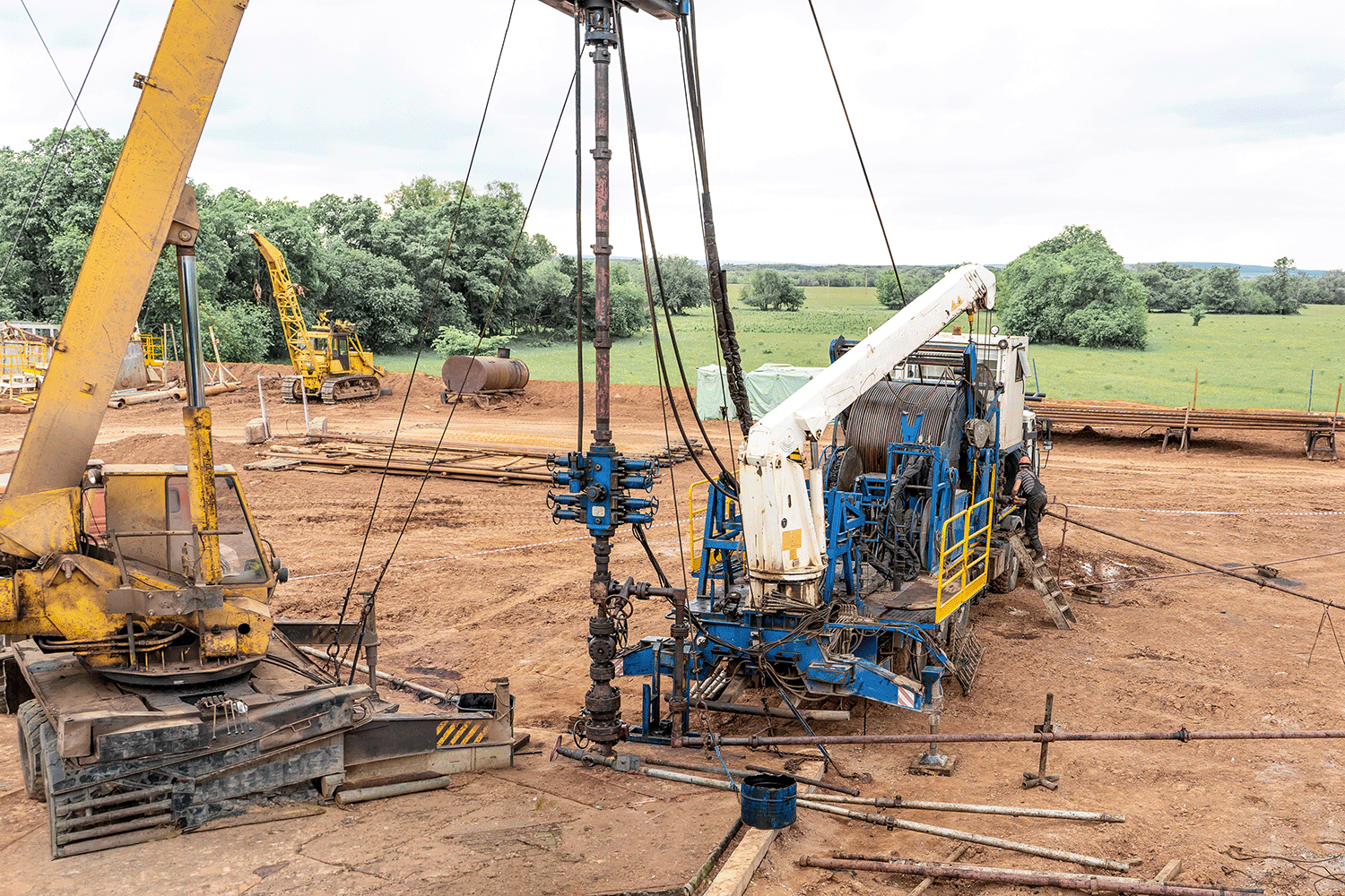 Wireline equipment hanging from top drive ready to be lowered downhole for logging.